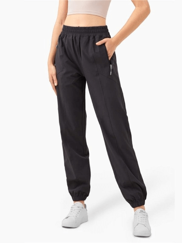 Loose women's high-waisted black yoga training pants with drawstring and ruffles, perfect for comfort and style during workouts.